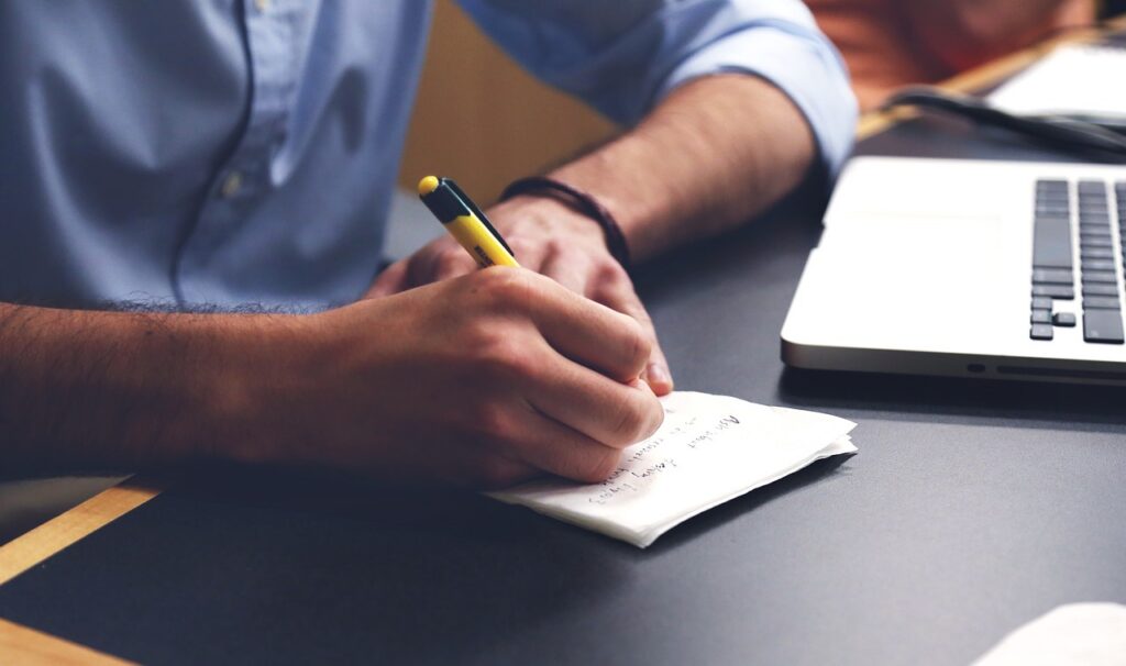A man writing a leadership skills development plan